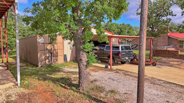 view of yard with an outbuilding and a carport