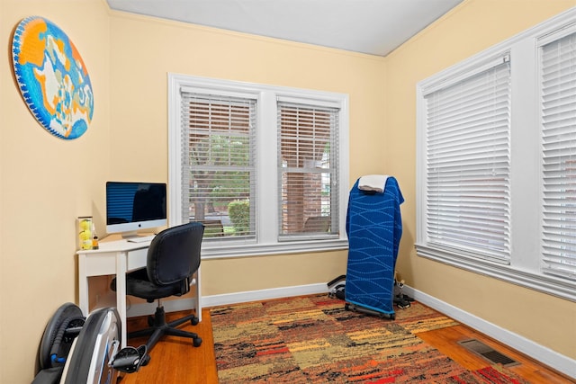 4204 Prescott Ave, Dallas, TX 75219 - home office with crown molding, baseboards, visible vents, and wood finished floors