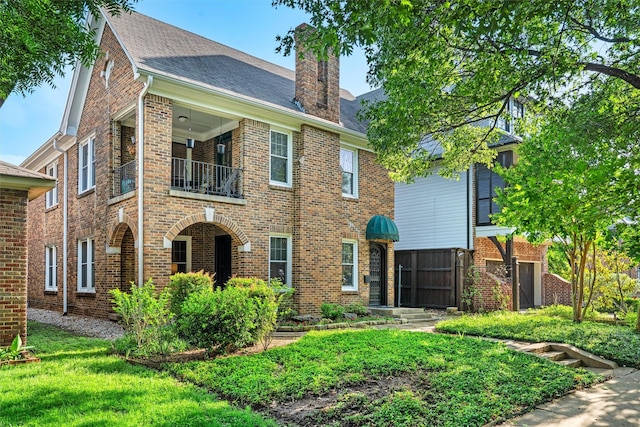 4204 Prescott Ave, Dallas, TX 75219 - view of front of home with brick siding, a chimney, a balcony, and roof with shingles
