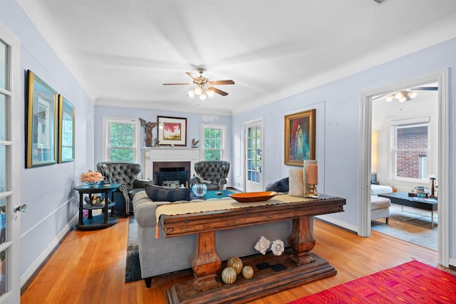 4204 Prescott Ave, Dallas, TX 75219 - living area featuring a ceiling fan, light wood-style floors, baseboards, and a fireplace
