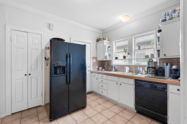 4204 Prescott Ave, Dallas, TX 75219 - kitchen featuring white cabinets, crown molding, light countertops, tasteful backsplash, and black appliances