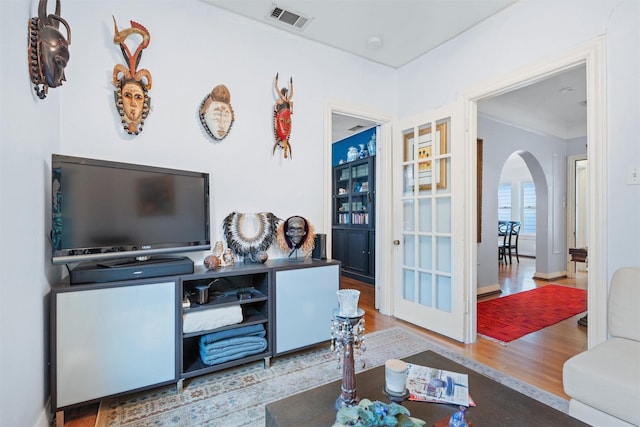 4204 Prescott Ave, Dallas, TX 75219 - living area with arched walkways, ornamental molding, wood finished floors, and visible vents