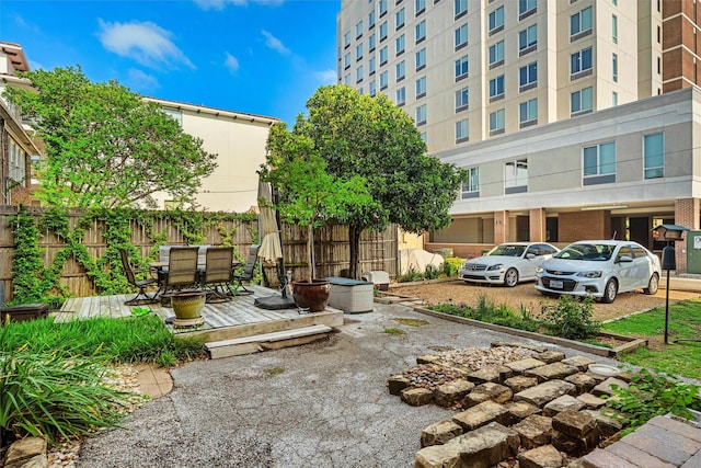4204 Prescott Ave, Dallas, TX 75219 - view of home's community featuring outdoor dining area, fence, and a wooden deck