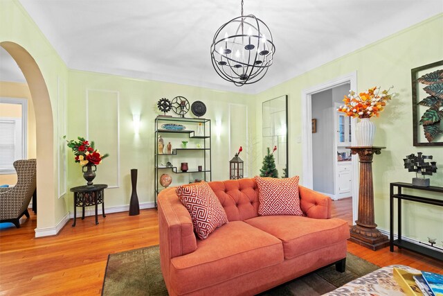4204 Prescott Ave, Dallas, TX 75219 - living room with baseboards, arched walkways, wood finished floors, and a chandelier