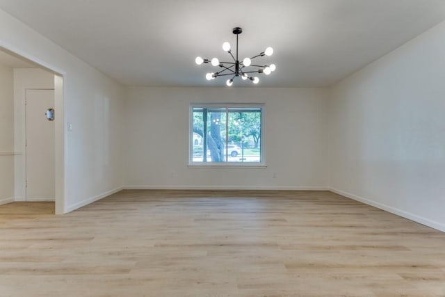 6148 Wrigley Way, Fort Worth, TX 76133 - empty room featuring baseboards, light wood-style flooring, and a chandelier