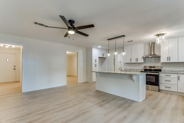 6148 Wrigley Way, Fort Worth, TX 76133 - kitchen with visible vents, wall chimney exhaust hood, white cabinetry, light wood finished floors, and stainless steel range with electric cooktop