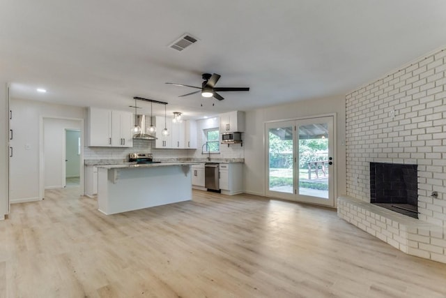6148 Wrigley Way, Fort Worth, TX 76133 - kitchen with white cabinets, visible vents, appliances with stainless steel finishes, and wall chimney exhaust hood