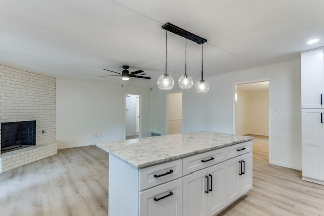 6148 Wrigley Way, Fort Worth, TX 76133 - kitchen featuring white cabinetry, ceiling fan, open floor plan, and light wood-type flooring