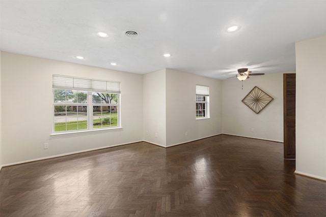spare room with a ceiling fan, baseboards, recessed lighting, and a wealth of natural light