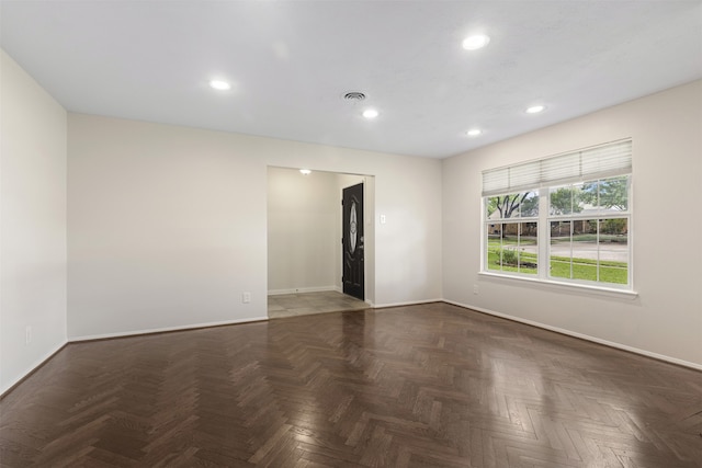 unfurnished room featuring baseboards, recessed lighting, and visible vents