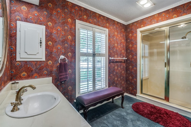 6555 Dartbrook Dr, Dallas, TX 75254 - bathroom featuring wallpapered walls, a textured ceiling, a shower with shower door, crown molding, and vanity