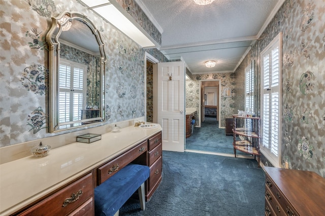 6555 Dartbrook Dr, Dallas, TX 75254 - bathroom with wallpapered walls, a textured ceiling, healthy amount of natural light, ornamental molding, and vanity