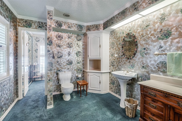 6555 Dartbrook Dr, Dallas, TX 75254 - bathroom with wallpapered walls, ornamental molding, toilet, a textured ceiling, and baseboards