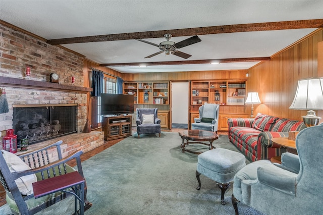 6555 Dartbrook Dr, Dallas, TX 75254 - living area with beamed ceiling, wooden walls, carpet floors, ceiling fan, and a brick fireplace