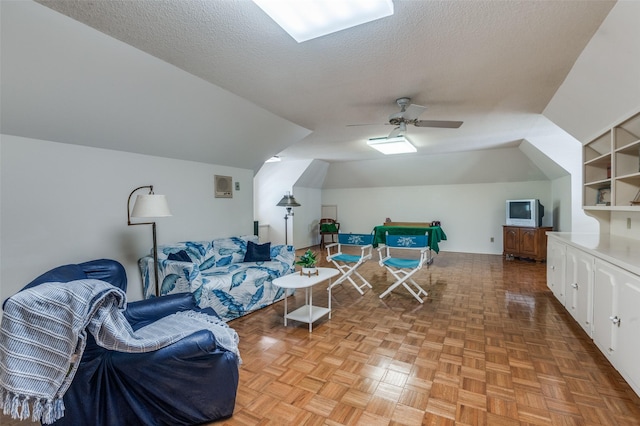 6555 Dartbrook Dr, Dallas, TX 75254 - living area featuring a textured ceiling, vaulted ceiling, and a ceiling fan