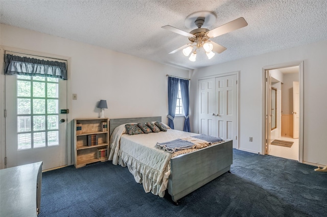 6555 Dartbrook Dr, Dallas, TX 75254 - bedroom featuring dark colored carpet, a textured ceiling, a closet, a ceiling fan, and ensuite bath