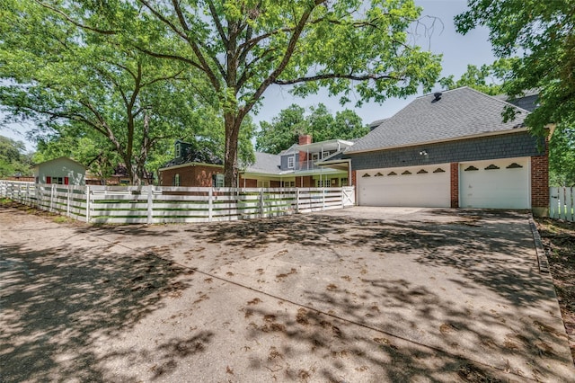6555 Dartbrook Dr, Dallas, TX 75254 - view of property exterior with brick siding, concrete driveway, fence, and a garage