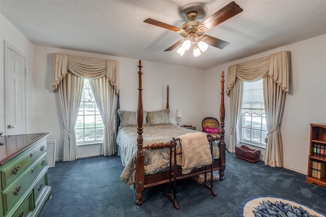 6555 Dartbrook Dr, Dallas, TX 75254 - bedroom featuring dark carpet, a textured ceiling, a ceiling fan, and baseboards