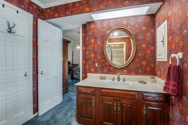 6555 Dartbrook Dr, Dallas, TX 75254 - full bath with a skylight, wallpapered walls, vanity, and connected bathroom