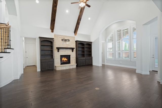 unfurnished living room featuring ceiling fan, a fireplace, high vaulted ceiling, baseboards, and dark wood-style floors