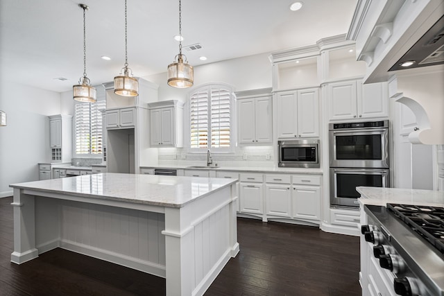 kitchen with backsplash, appliances with stainless steel finishes, plenty of natural light, and a sink