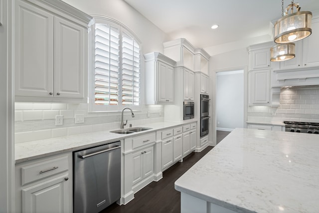 kitchen featuring decorative backsplash, a sink, white cabinets, dark wood-style floors, and stainless steel appliances