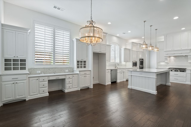 kitchen featuring a sink, light countertops, stainless steel appliances, decorative backsplash, and visible vents
