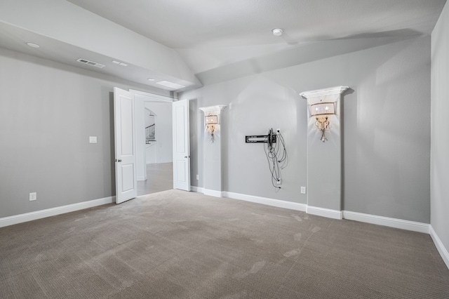 unfurnished bedroom with carpet floors, baseboards, lofted ceiling, and visible vents