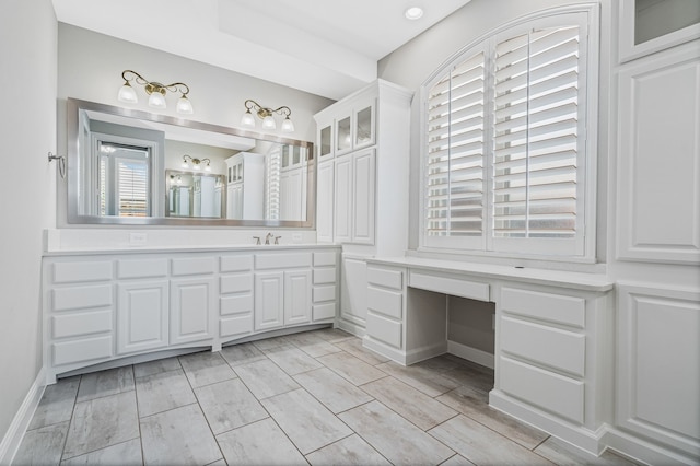 bathroom with baseboards and vanity