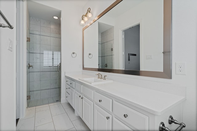 bathroom with vanity, marble finish floor, and a stall shower