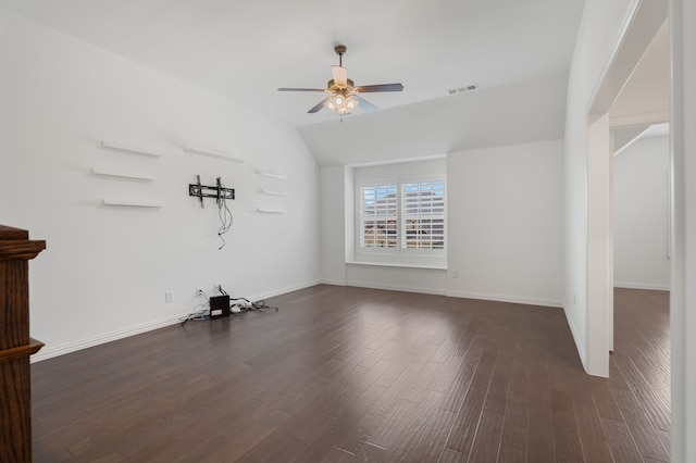 interior space featuring ceiling fan, dark wood-style flooring, visible vents, baseboards, and lofted ceiling