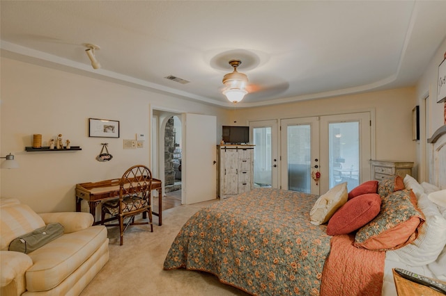 bedroom with visible vents, light carpet, access to outside, french doors, and a ceiling fan