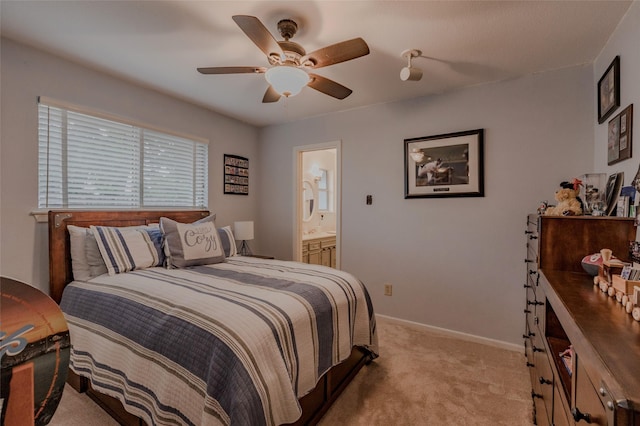 bedroom featuring baseboards, ceiling fan, connected bathroom, and light colored carpet