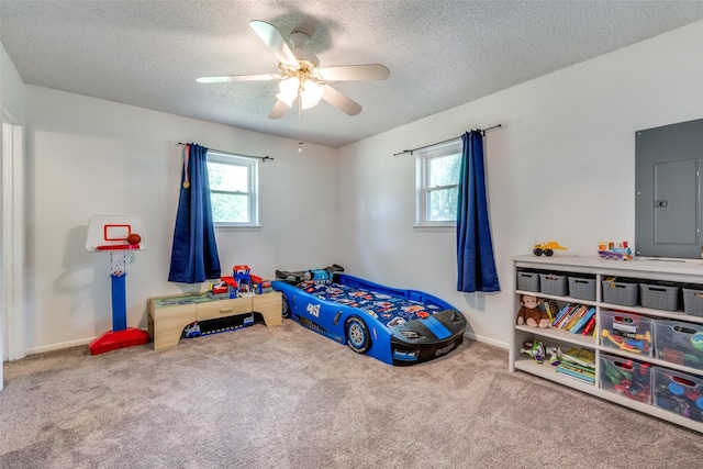 bedroom featuring a textured ceiling, carpet, ceiling fan, and electric panel
