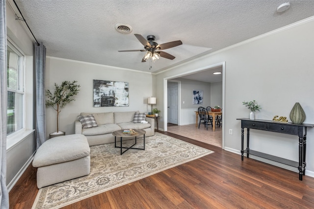 living room featuring plenty of natural light, a textured ceiling, ceiling fan, and wood finished floors