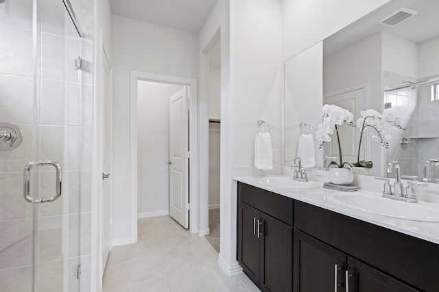 2021 Pine Stone Ln, Forney, TX 75126 - full bathroom featuring visible vents, a sink, and a shower stall