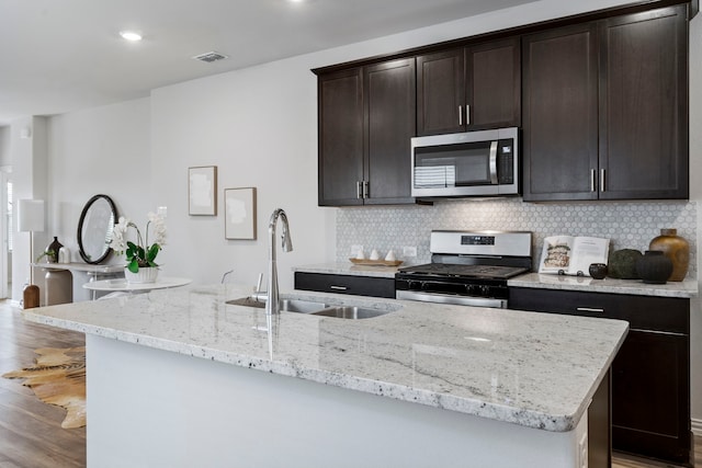 2021 Pine Stone Ln, Forney, TX 75126 - kitchen with appliances with stainless steel finishes, a sink, visible vents, and light wood-type flooring