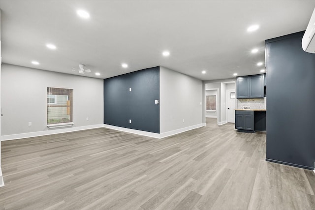 217 N Hawkins St, Waxahachie, TX 75165 - unfurnished living room featuring recessed lighting, baseboards, and light wood-style floors