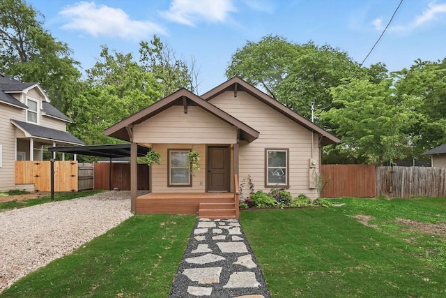 217 N Hawkins St, Waxahachie, TX 75165 - bungalow featuring covered porch, fence, a front lawn, and gravel driveway