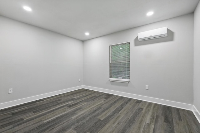 217 N Hawkins St, Waxahachie, TX 75165 - empty room featuring recessed lighting, dark wood finished floors, and a wall unit AC