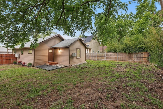 217 N Hawkins St, Waxahachie, TX 75165 - back of house featuring a lawn and a fenced backyard