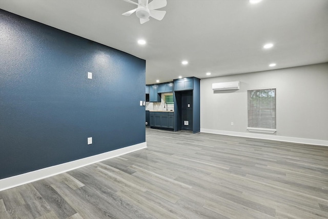 217 N Hawkins St, Waxahachie, TX 75165 - unfurnished living room with light wood finished floors, a ceiling fan, recessed lighting, and a wall mounted air conditioner
