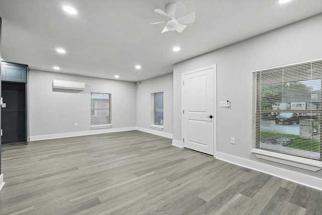217 N Hawkins St, Waxahachie, TX 75165 - interior space with a ceiling fan, a wall mounted AC, baseboards, recessed lighting, and light wood-style flooring