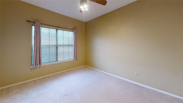 unfurnished room featuring carpet floors, a ceiling fan, and baseboards