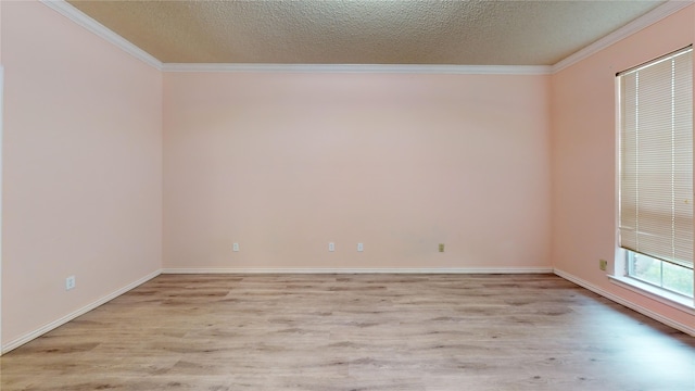 empty room with a textured ceiling, ornamental molding, and light wood-type flooring