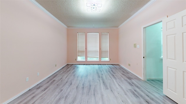 empty room featuring baseboards, a textured ceiling, ornamental molding, and light wood-style flooring