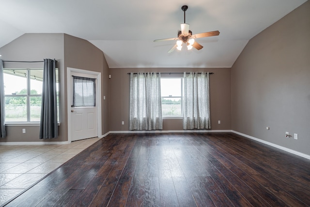 unfurnished living room featuring a ceiling fan, plenty of natural light, and lofted ceiling