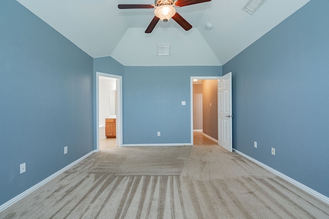 unfurnished bedroom featuring carpet, vaulted ceiling, and visible vents