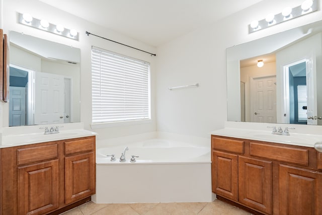 bathroom featuring a bath, two vanities, a sink, and tile patterned flooring