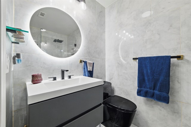 5243 Welden Ct, Fort Worth, TX 76132 - full bathroom featuring visible vents, tile walls, a shower, vanity, and toilet
